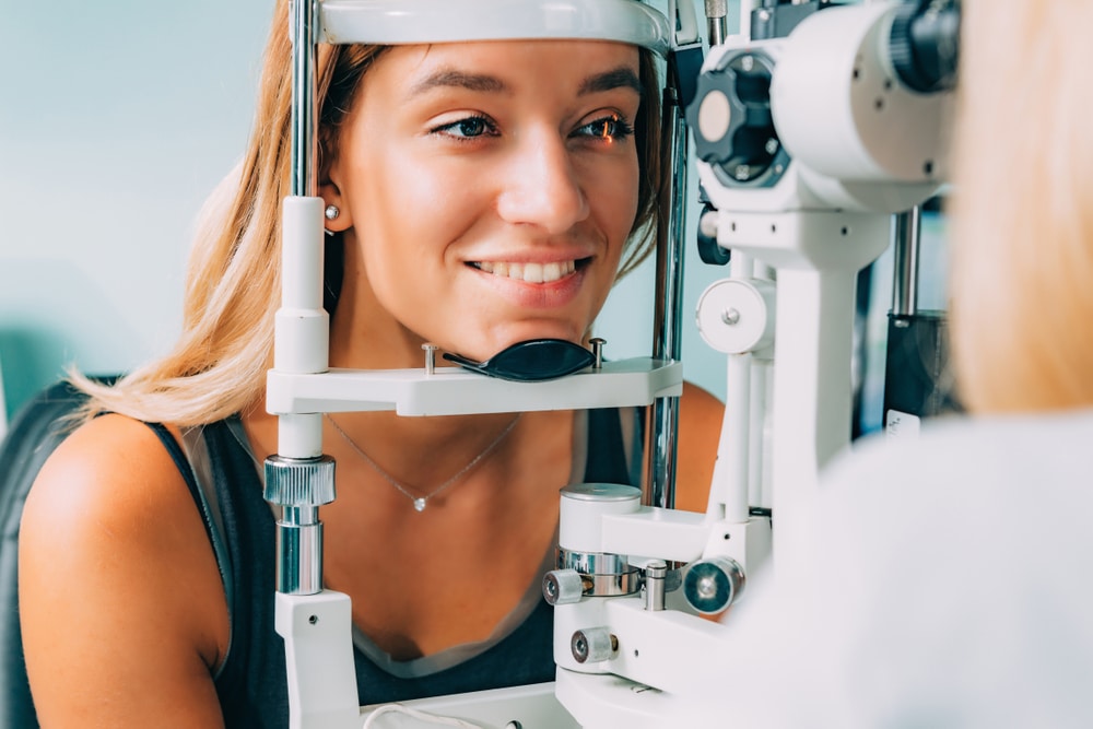 Young woman at eye doctor getting eye exam in preparation for EVO ICL procedure.